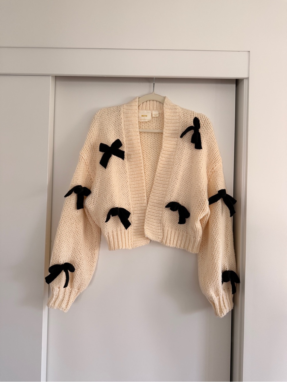 Anthropologie Cream Cropped Knit Cardigan with Black Bow Accents
